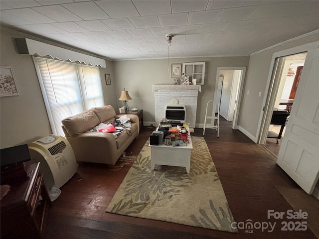 living room featuring dark hardwood / wood-style flooring and ornamental molding