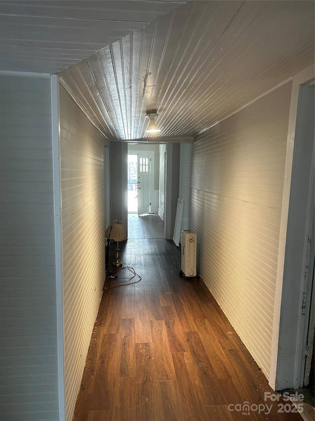 hall featuring dark wood-type flooring and wood ceiling