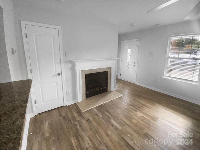 unfurnished living room featuring dark wood-type flooring