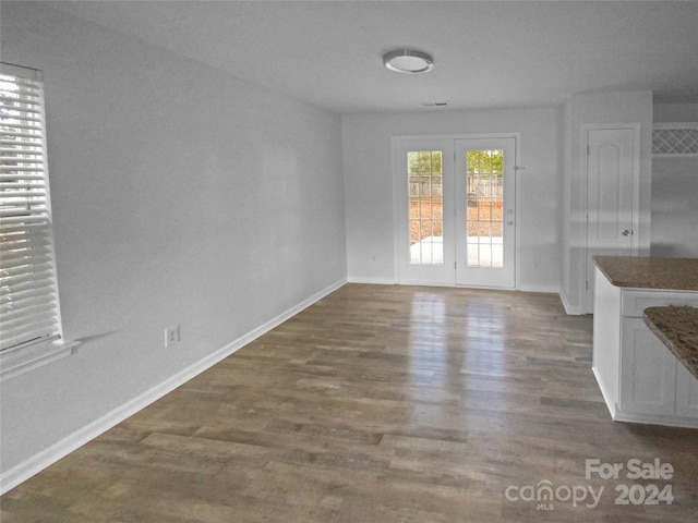 unfurnished dining area with dark hardwood / wood-style floors