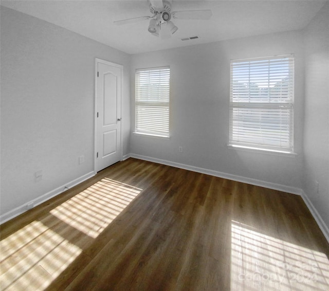 spare room featuring ceiling fan and dark hardwood / wood-style flooring