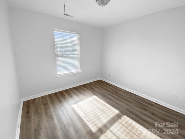 empty room with hardwood / wood-style floors