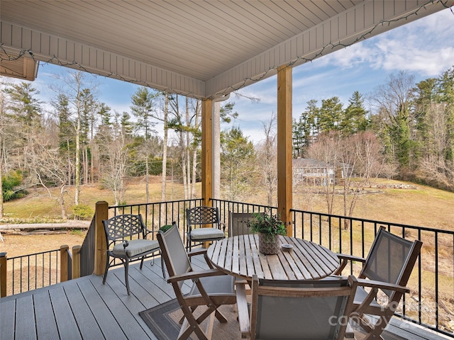 wooden deck featuring outdoor dining area