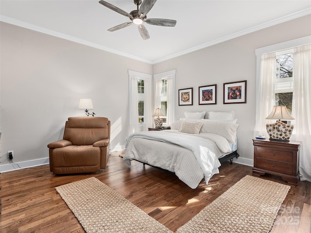 bedroom featuring ceiling fan, ornamental molding, wood finished floors, and baseboards