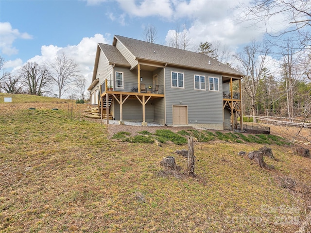 rear view of property with stairs and a deck