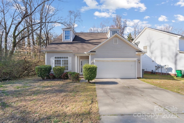 view of front of house featuring a front yard, a garage, and driveway