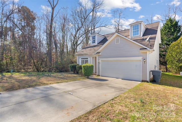 view of front of home with a garage, concrete driveway, and a front lawn