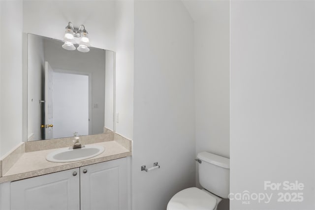 half bathroom featuring toilet and vanity