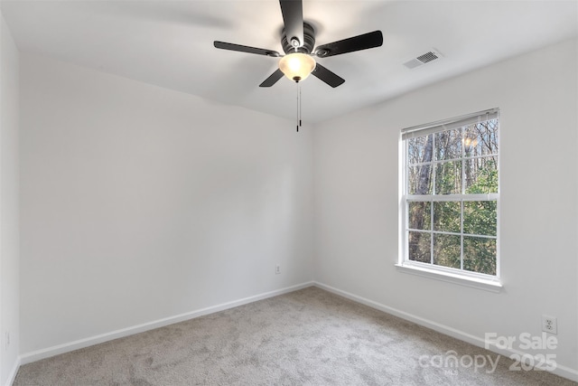 carpeted empty room featuring visible vents, plenty of natural light, and baseboards