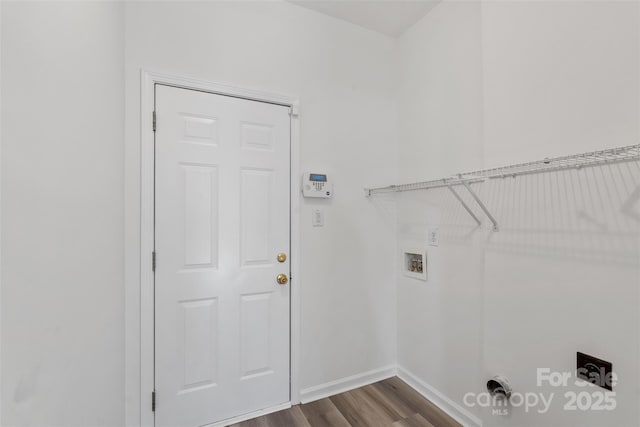 clothes washing area featuring hookup for a washing machine, baseboards, hookup for an electric dryer, laundry area, and dark wood-style flooring