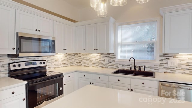 kitchen featuring white cabinets, decorative backsplash, sink, and stainless steel appliances