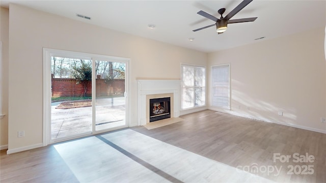 unfurnished living room with light hardwood / wood-style flooring and ceiling fan