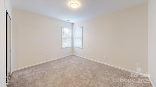 empty room with light colored carpet