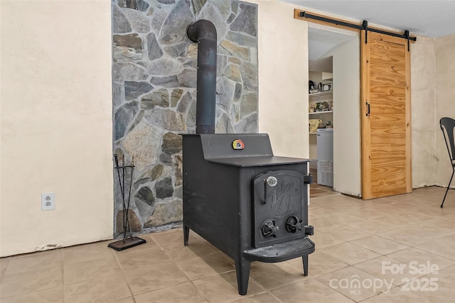 room details featuring a wood stove and a barn door