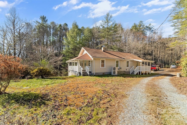 view of front of house with ac unit and covered porch