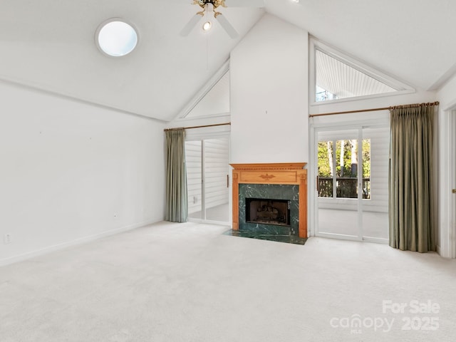 unfurnished living room featuring carpet, high vaulted ceiling, and a high end fireplace