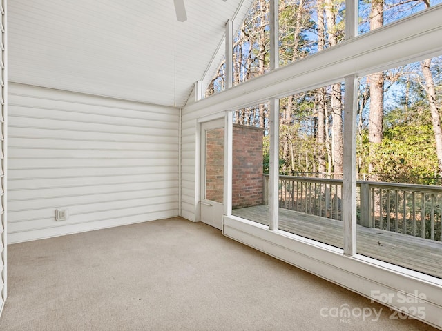 unfurnished sunroom with plenty of natural light, ceiling fan, and lofted ceiling