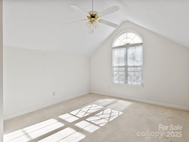 additional living space featuring light carpet, vaulted ceiling, and ceiling fan