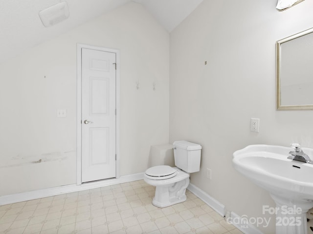 bathroom with toilet and vaulted ceiling