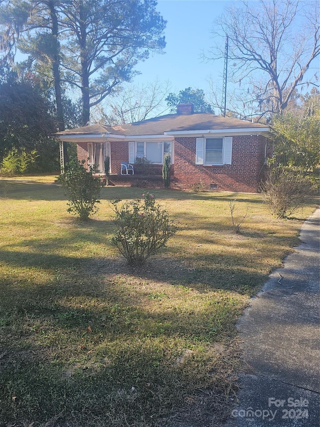 ranch-style house with a front lawn