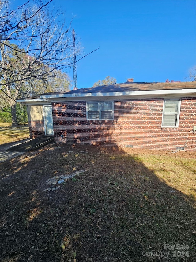 view of home's exterior with a yard