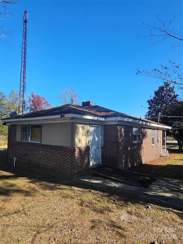 rear view of property with a lawn