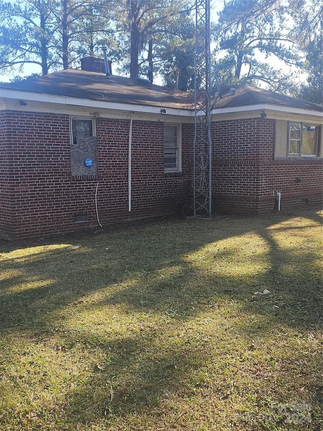 back of house with a yard