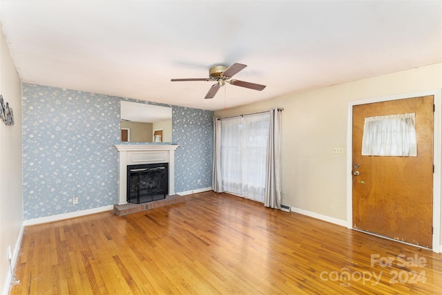 unfurnished living room featuring ceiling fan and hardwood / wood-style floors