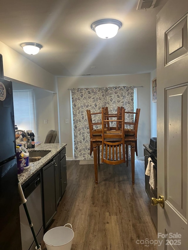 dining space with dark hardwood / wood-style flooring and sink