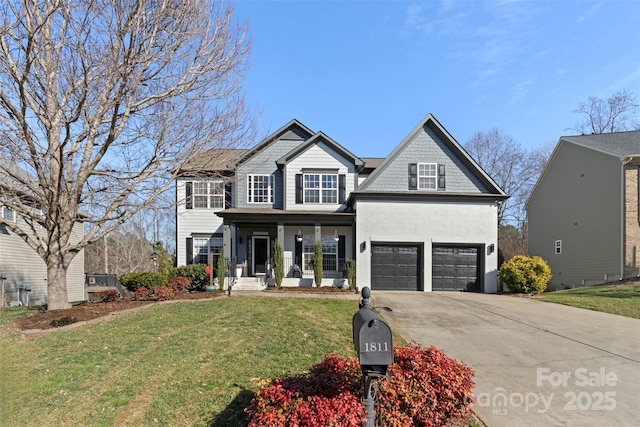 view of front of home featuring a garage, covered porch, and a front lawn