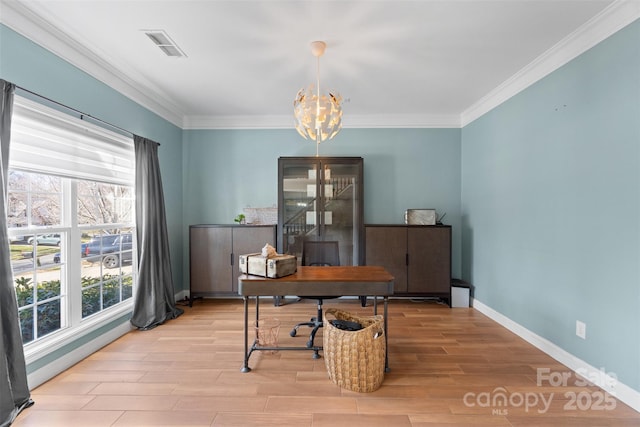 home office with ornamental molding, light wood-type flooring, and an inviting chandelier