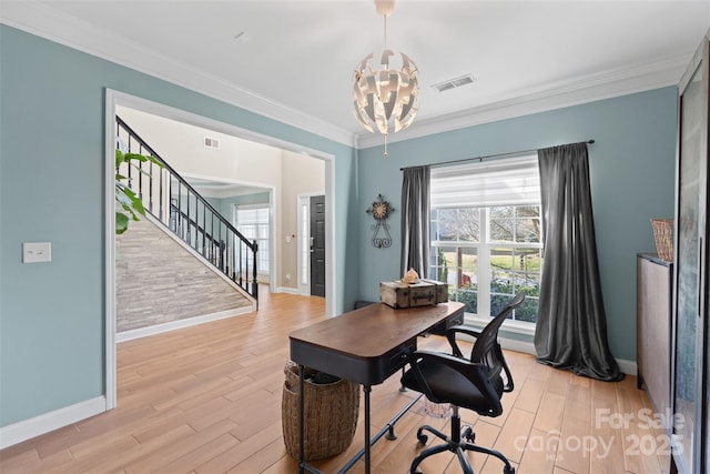 office area featuring an inviting chandelier, ornamental molding, and light wood-type flooring