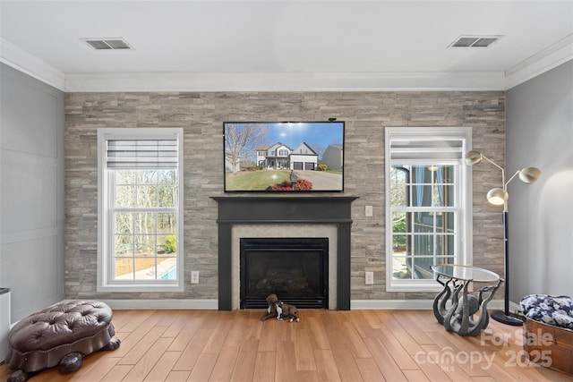 sitting room featuring hardwood / wood-style floors and crown molding