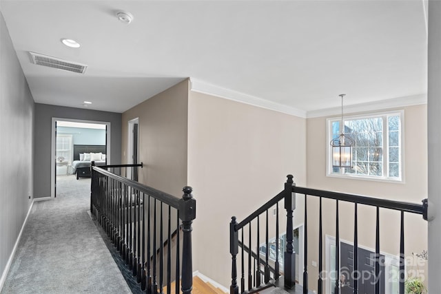 corridor featuring crown molding and light carpet