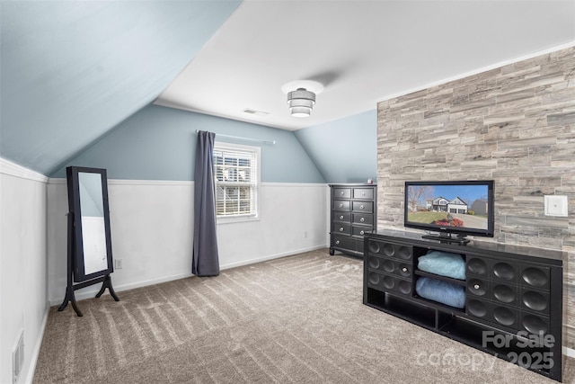 interior space with lofted ceiling and carpet flooring