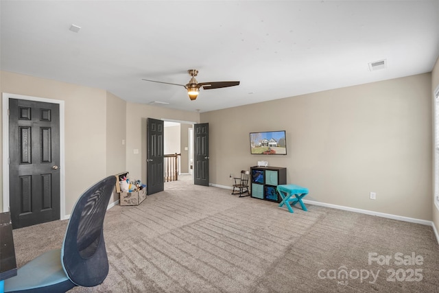 interior space featuring light colored carpet and ceiling fan