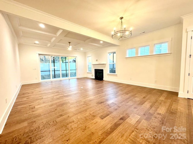 unfurnished living room with crown molding, a chandelier, coffered ceiling, wood-type flooring, and beamed ceiling