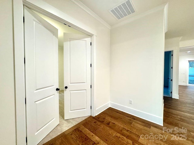 interior space with crown molding and wood-type flooring