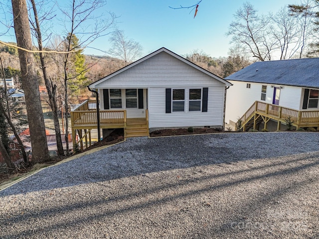 view of front facade with crawl space, stairway, and a deck