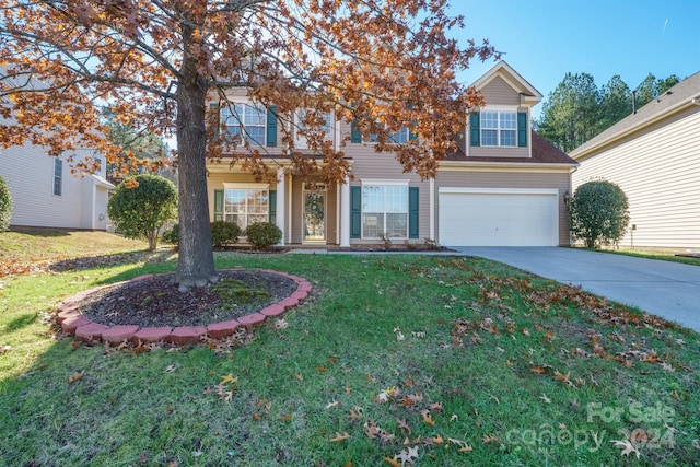 view of front of home with a garage and a front lawn