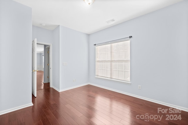 spare room featuring dark hardwood / wood-style floors