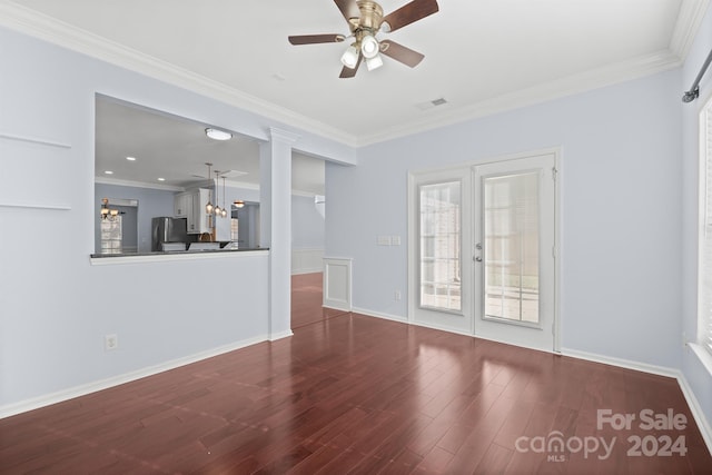 unfurnished living room featuring hardwood / wood-style floors, ceiling fan, and crown molding