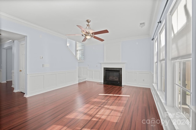 unfurnished living room featuring ornamental molding, ceiling fan, dark wood-type flooring, and a premium fireplace