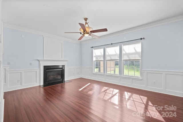 unfurnished living room featuring crown molding, hardwood / wood-style floors, a high end fireplace, and ceiling fan