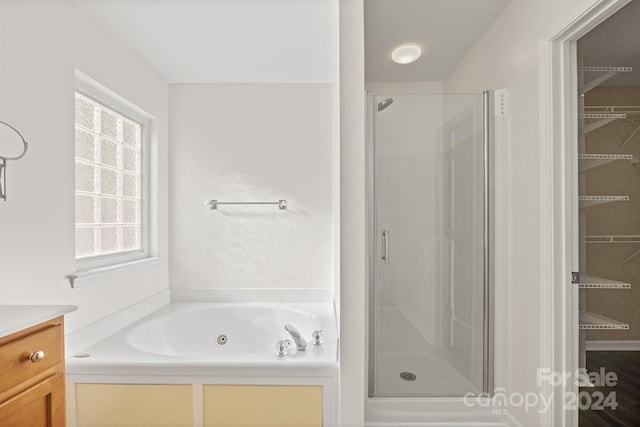 bathroom with shower with separate bathtub, vanity, and plenty of natural light