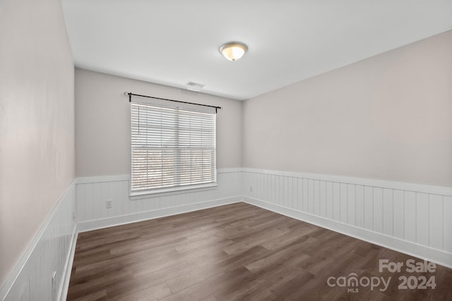 spare room featuring dark hardwood / wood-style flooring