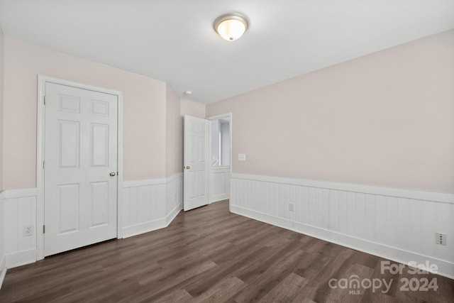 unfurnished bedroom featuring dark hardwood / wood-style flooring and a closet