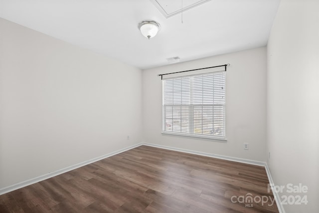 spare room with wood-type flooring