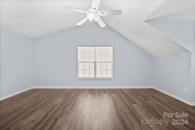 additional living space featuring dark hardwood / wood-style floors, ceiling fan, and lofted ceiling