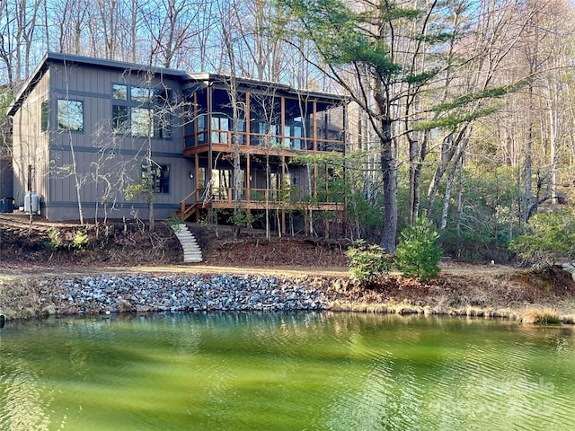 rear view of house featuring a water view